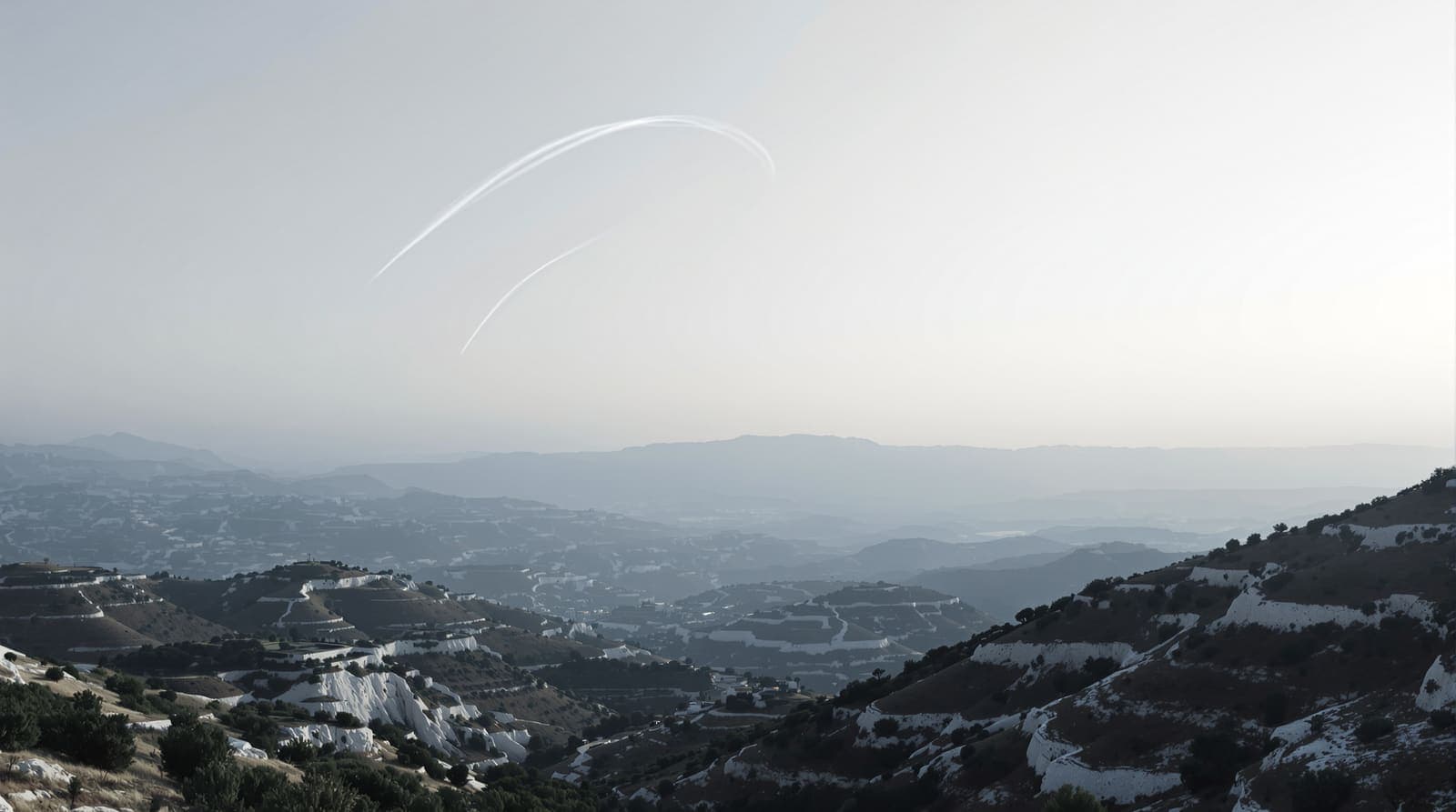 Illustration of a white contrail arcing over the scrub hills and terraced ridges of southern Lebanon at dusk