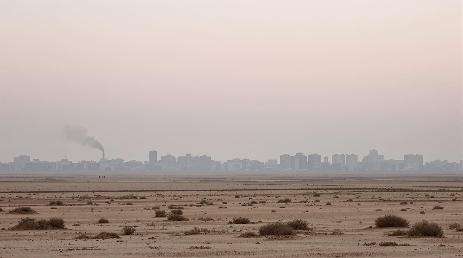 Illustration of the hazed Gaza City skyline seen from distant farmland at dawn under an overcast sky.