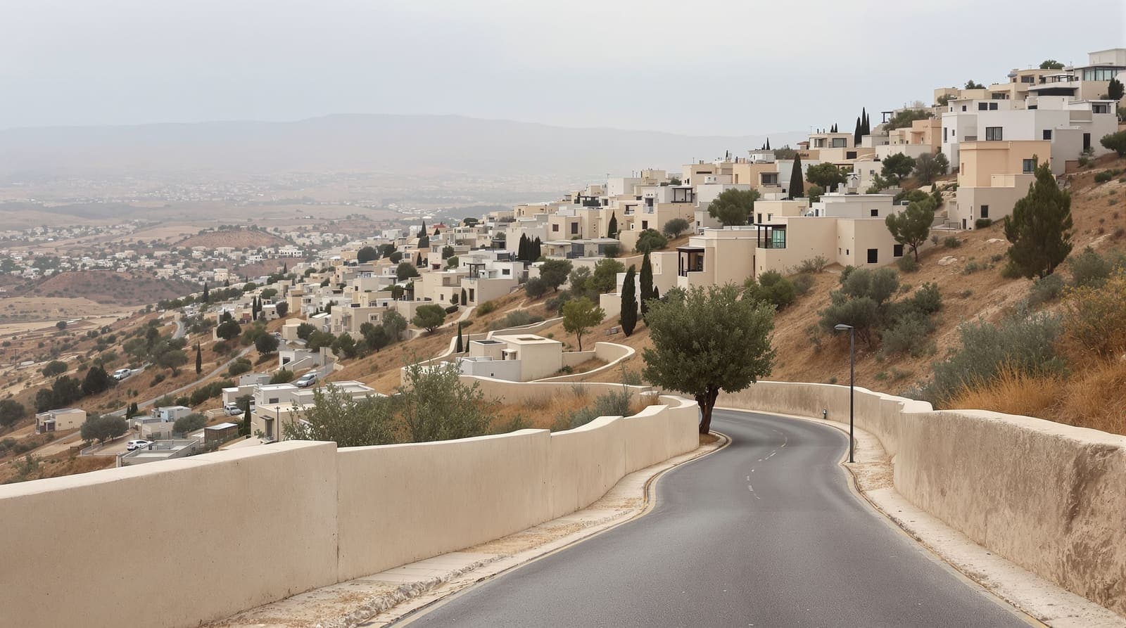 Illustration of an empty hillside street among pale concrete houses in Umm al-Fahm under an overcast morning sky
