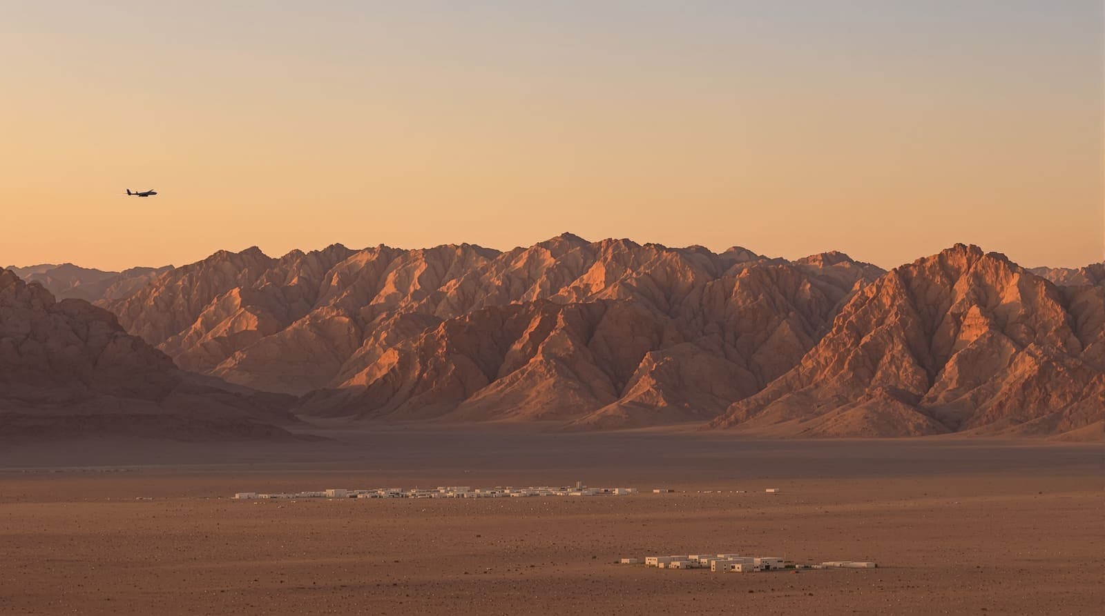 Illustration of rocky Hejaz mountains at dusk with a small drone silhouette high in a hazy amber sky above distant low buildings.