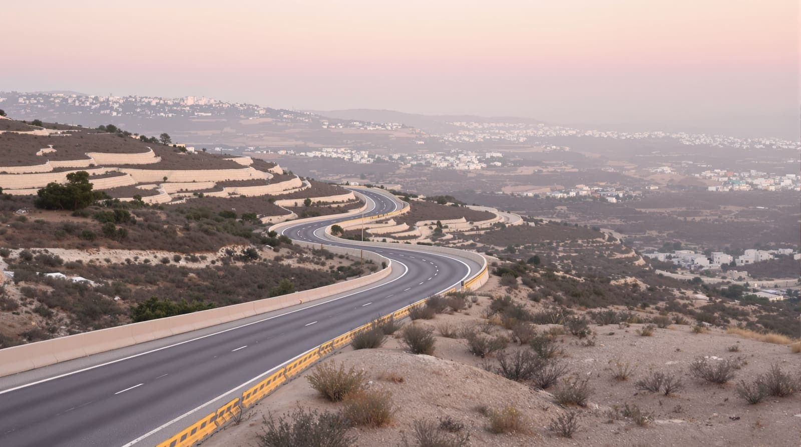Illustration of an empty two-lane highway curving through olive-terraced hills under a hazy dawn sky.