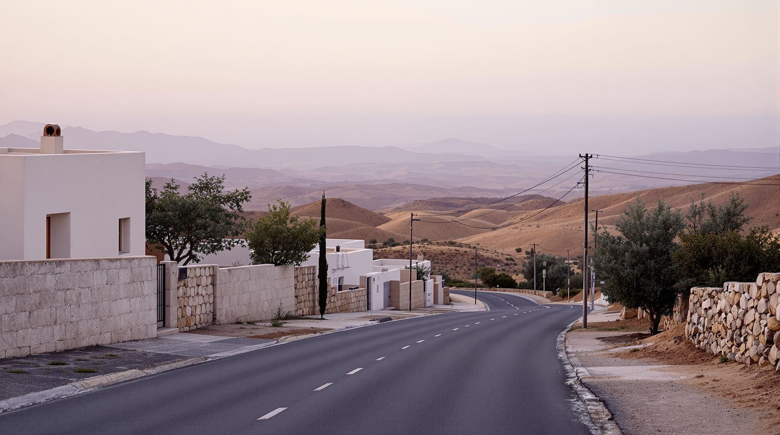 Illustration of a quiet residential street in a Lower Galilee hillside village at dusk, with stone houses, olive trees and distant hills.