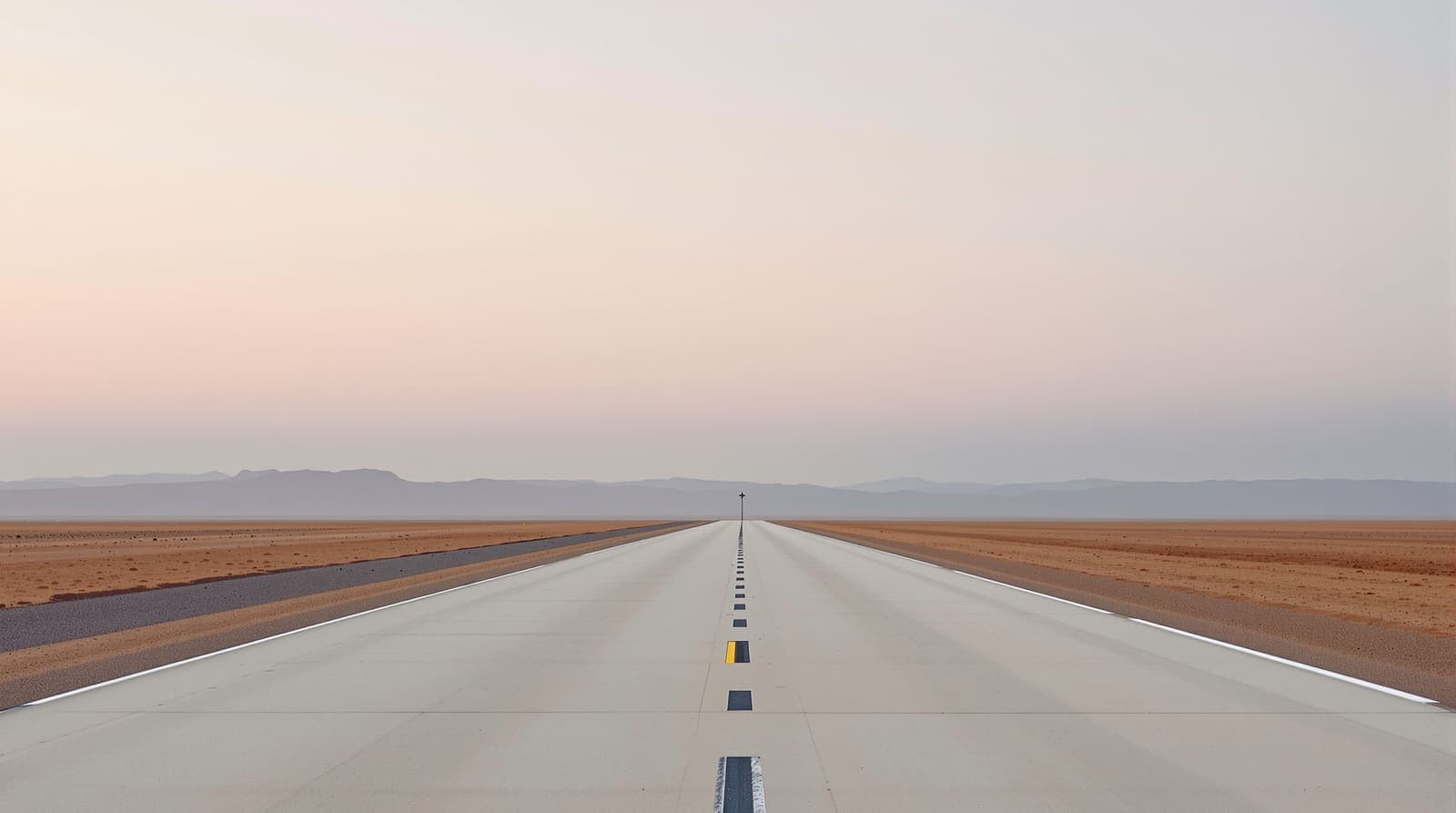 Illustration of an empty desert runway stretching toward a low ridgeline at dawn, with scrub and gravel along its edges under an overcast sky.