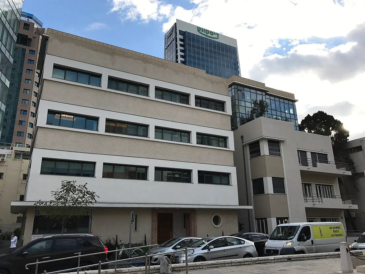 International Style houses at 18 and 20 Rothschild Boulevard, towers rising behind them